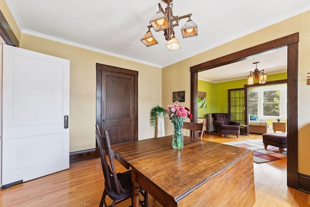 1725 Hague Ave Unit 4, Saint Paul, MN 55104 - dining area featuring a chandelier, light wood-type flooring, and ornamental molding