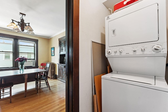 1725 Hague Ave Unit 4, Saint Paul, MN 55104 - laundry area with estacked washer and dryer, crown molding, light wood-style flooring, and cooling unit