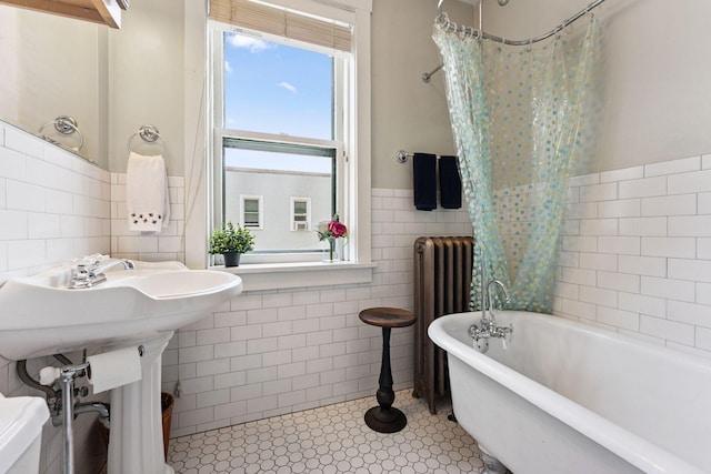 1725 Hague Ave Unit 4, Saint Paul, MN 55104 - bathroom featuring tile walls, radiator, a soaking tub, wainscoting, and a shower with shower curtain