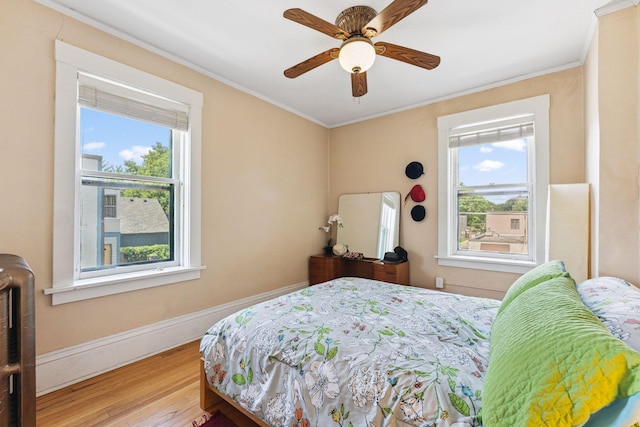 1725 Hague Ave Unit 4, Saint Paul, MN 55104 - bedroom with multiple windows, wood finished floors, ornamental molding, and a ceiling fan