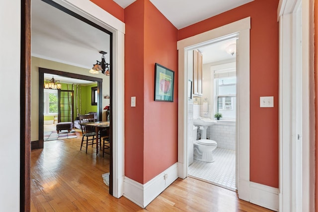 1725 Hague Ave Unit 4, Saint Paul, MN 55104 - hallway featuring a chandelier and light wood finished floors