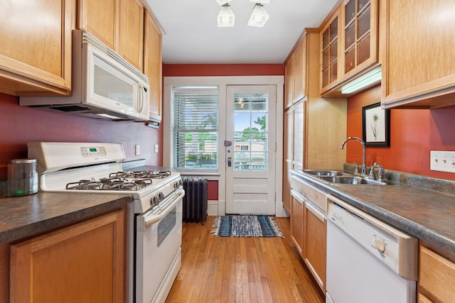 1725 Hague Ave Unit 4, Saint Paul, MN 55104 - kitchen with white appliances, light wood-style floors, dark countertops, radiator heating unit, and glass insert cabinets