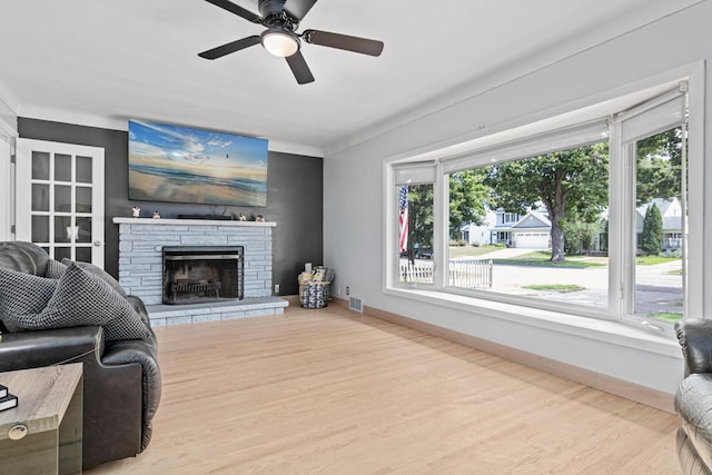 957 Hall Ave W, Saint Paul, MN 55118 - living area with healthy amount of natural light, wood finished floors, a ceiling fan, and a stone fireplace