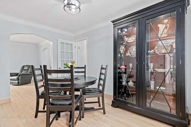 957 Hall Ave W, Saint Paul, MN 55118 - dining room featuring arched walkways, light wood-type flooring, french doors, and crown molding