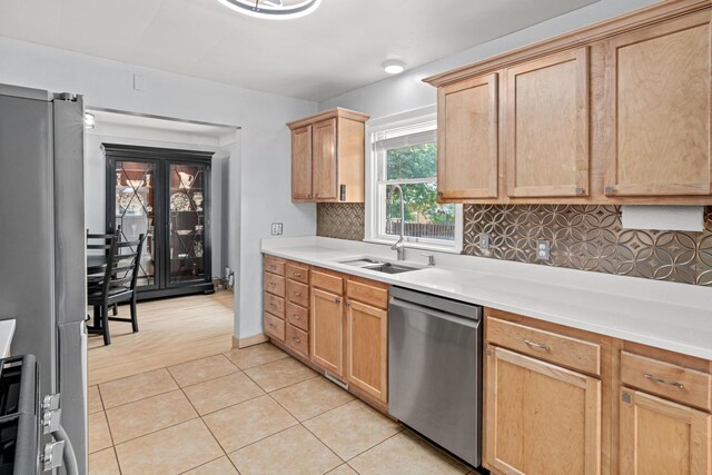 957 Hall Ave W, Saint Paul, MN 55118 - kitchen with appliances with stainless steel finishes, tasteful backsplash, light tile patterned flooring, light countertops, and light brown cabinets