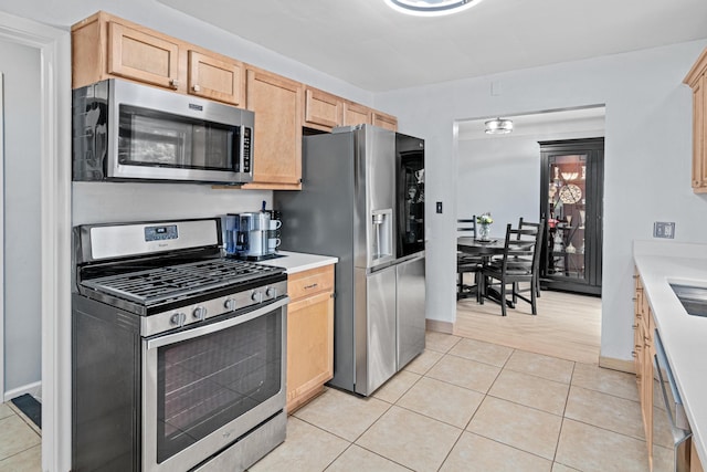 957 Hall Ave W, Saint Paul, MN 55118 - kitchen featuring appliances with stainless steel finishes, light brown cabinetry, light countertops, and light tile patterned floors