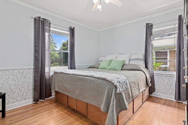 957 Hall Ave W, Saint Paul, MN 55118 - bedroom with light wood finished floors, wallpapered walls, ornamental molding, and a ceiling fan