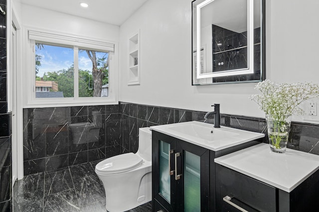 957 Hall Ave W, Saint Paul, MN 55118 - bathroom with vanity, tile walls, marble look tiles, recessed lighting, and a wainscoted wall