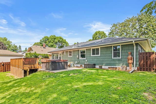957 Hall Ave W, Saint Paul, MN 55118 - back of property with a hot tub, a fenced backyard, a patio, a deck, and a shingled roof