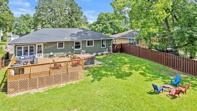 957 Hall Ave W, Saint Paul, MN 55118 - back of house featuring a fenced backyard, a wooden deck, an outdoor fire pit, roof with shingles, and a chimney