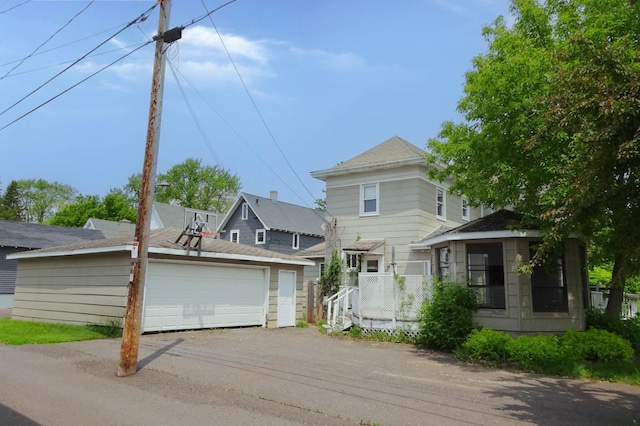 2332 7th St, Superior, WI 54880 - view of front of house featuring a detached garage, an outbuilding, and roof with shingles