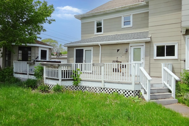 2332 7th St, Superior, WI 54880 - back of house with roof with shingles, a wooden deck, and a lawn
