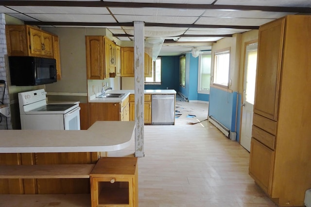 2332 7th St, Superior, WI 54880 - kitchen with black microwave, white range with electric stovetop, baseboard heating, stainless steel dishwasher, and light wood-style floors