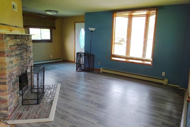 2332 7th St, Superior, WI 54880 - unfurnished living room with a baseboard heating unit and wood finished floors