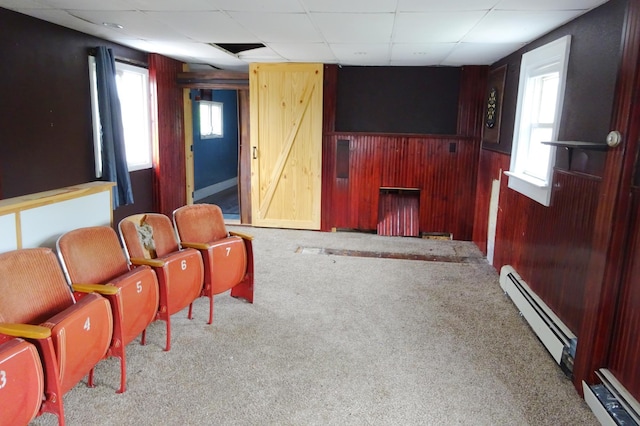 2332 7th St, Superior, WI 54880 - carpeted cinema featuring baseboard heating, wooden walls, and a drop ceiling