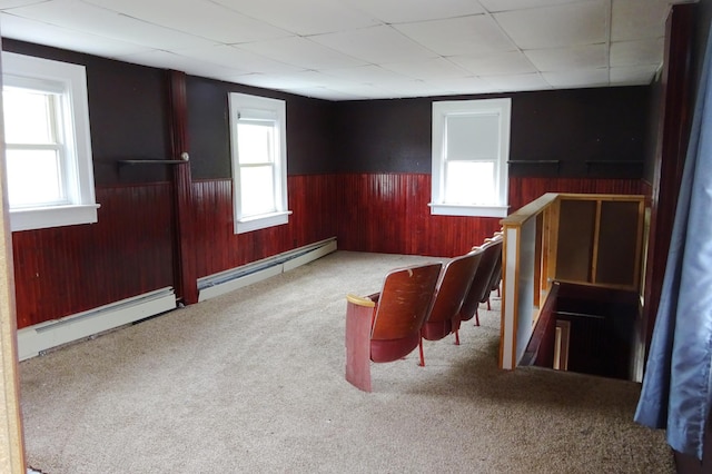 2332 7th St, Superior, WI 54880 - carpeted spare room featuring a baseboard radiator, wainscoting, healthy amount of natural light, wooden walls, and a paneled ceiling