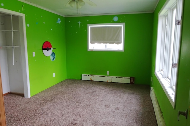 2332 7th St, Superior, WI 54880 - unfurnished bedroom with baseboard heating, carpet, crown molding, and a closet