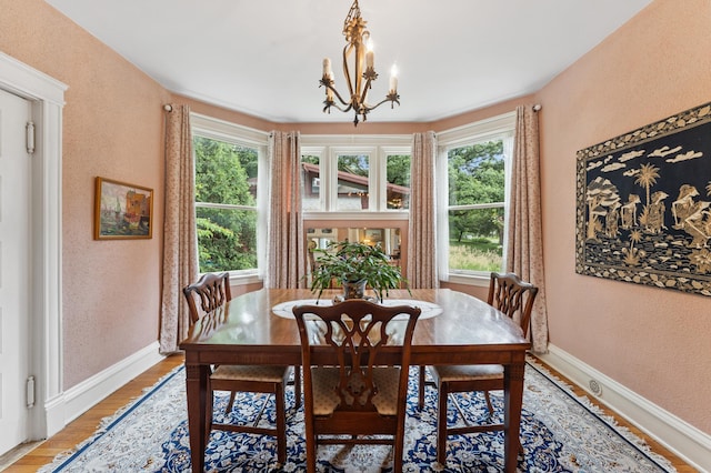 2145 Knapp St, Saint Paul, MN 55108 - dining room with a chandelier, light wood finished floors, and a textured wall