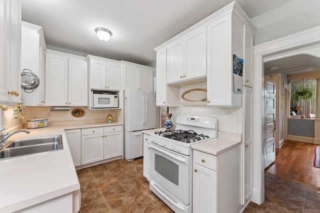 2145 Knapp St, Saint Paul, MN 55108 - kitchen with white appliances, white cabinetry, tasteful backsplash, and light countertops