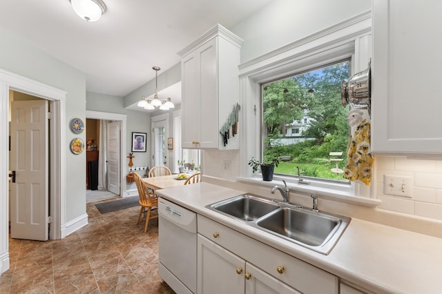2145 Knapp St, Saint Paul, MN 55108 - kitchen with white dishwasher, backsplash, white cabinetry, light countertops, and a chandelier