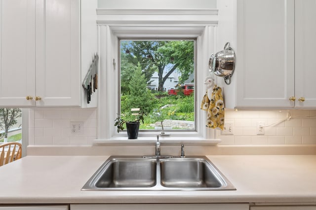 2145 Knapp St, Saint Paul, MN 55108 - kitchen with light countertops, white cabinetry, and tasteful backsplash