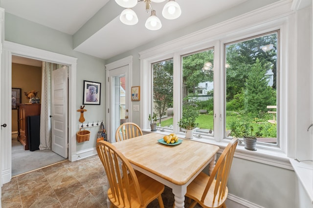 2145 Knapp St, Saint Paul, MN 55108 - dining space with a chandelier and light stone finish floors