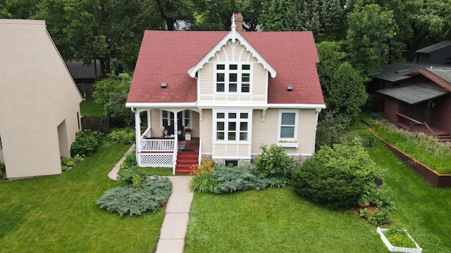 2145 Knapp St, Saint Paul, MN 55108 - victorian-style house featuring a porch, a front lawn, and a chimney