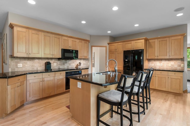 3933 Donegal Way, Eagan, MN 55122 - kitchen with black appliances, light wood finished floors, backsplash, light brown cabinets, and recessed lighting