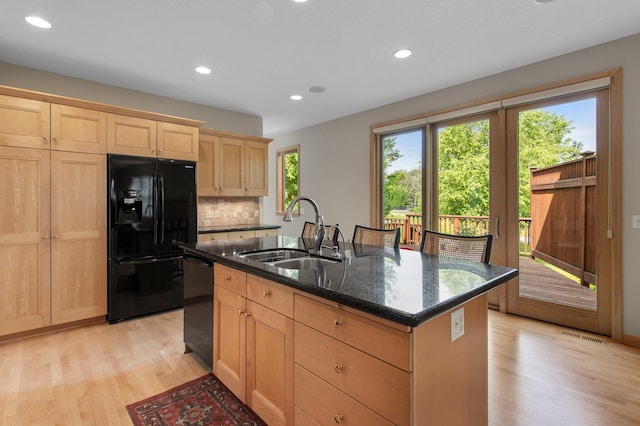 3933 Donegal Way, Eagan, MN 55122 - kitchen with black appliances, light brown cabinetry, light wood-type flooring, dark stone countertops, and recessed lighting