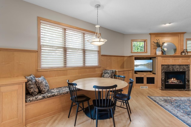 3933 Donegal Way, Eagan, MN 55122 - dining area with a wainscoted wall, wood finished floors, a premium fireplace, and wooden walls