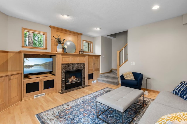 3933 Donegal Way, Eagan, MN 55122 - living room with stairway, light wood-style flooring, a premium fireplace, and recessed lighting