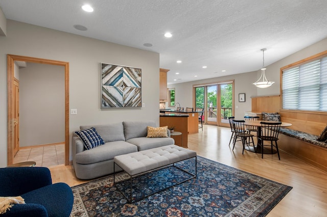 3933 Donegal Way, Eagan, MN 55122 - living area featuring a textured ceiling, recessed lighting, and light wood-style flooring
