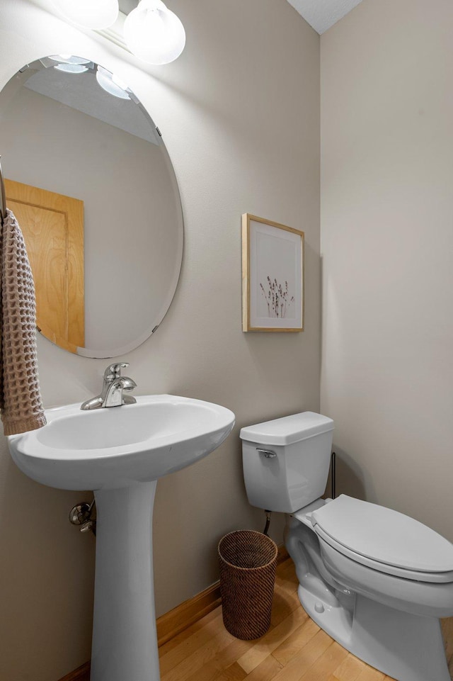 3933 Donegal Way, Eagan, MN 55122 - half bath featuring wood finished floors and toilet