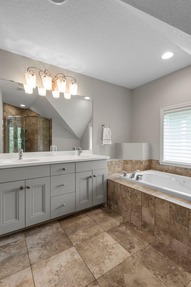 3933 Donegal Way, Eagan, MN 55122 - bathroom featuring double vanity, a shower stall, a garden tub, and a textured ceiling