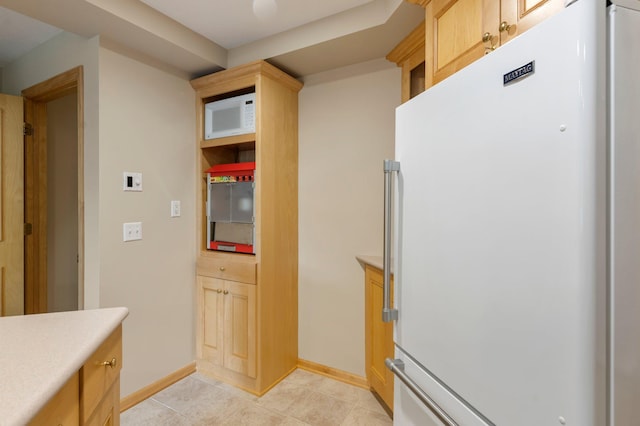 3933 Donegal Way, Eagan, MN 55122 - kitchen with refrigerator, light countertops, white microwave, light tile patterned floors, and light brown cabinets