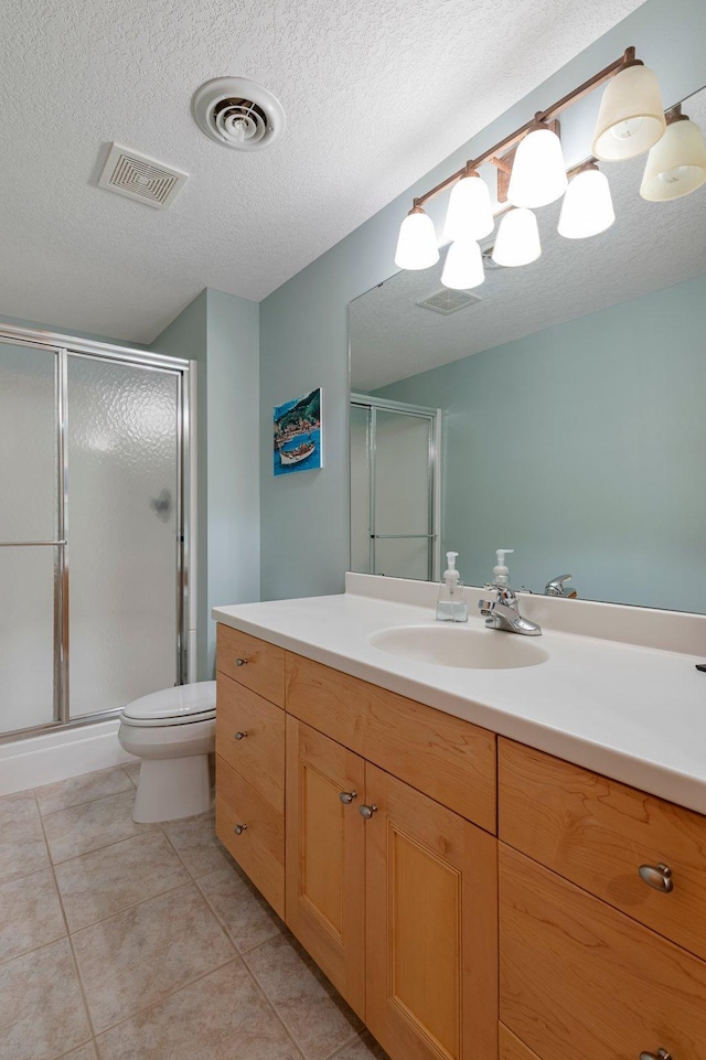 3933 Donegal Way, Eagan, MN 55122 - full bathroom featuring vanity, a shower stall, tile patterned floors, and a textured ceiling