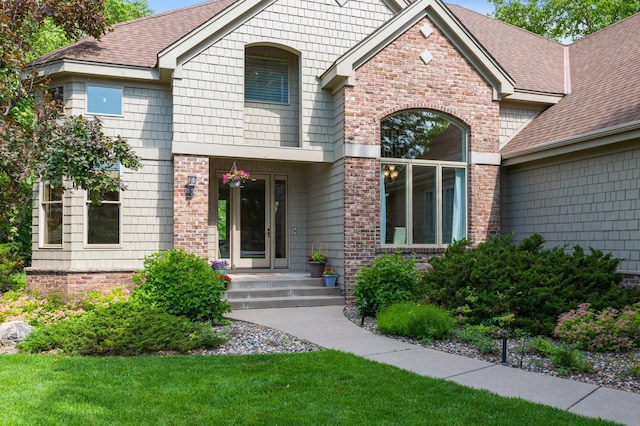 3933 Donegal Way, Eagan, MN 55122 - view of front facade featuring a shingled roof, a front lawn, and brick siding