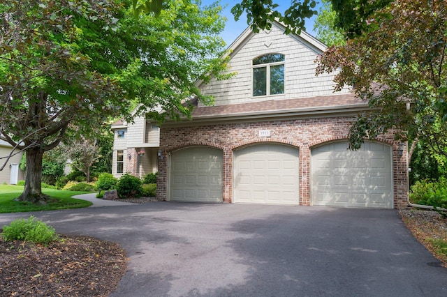 3933 Donegal Way, Eagan, MN 55122 - view of front of home featuring driveway, brick siding, an attached garage, and a shingled roof