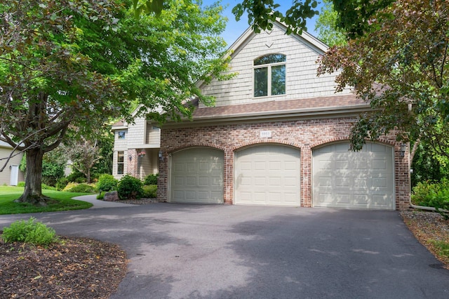 3933 Donegal Way, Eagan, MN 55122 - view of front of house with driveway, brick siding, a garage, and roof with shingles