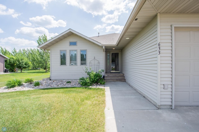 633 Leonards Way, Argusville, ND 58005 - doorway to property featuring a garage and a lawn