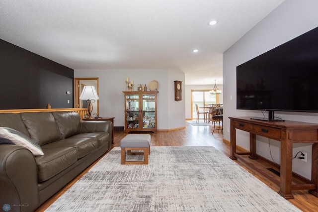 633 Leonards Way, Argusville, ND 58005 - living room featuring wood finished floors, a chandelier, and recessed lighting