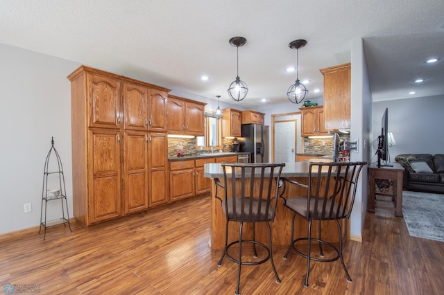 633 Leonards Way, Argusville, ND 58005 - kitchen with refrigerator with ice dispenser, dark wood-style floors, decorative backsplash, and recessed lighting