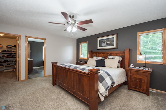633 Leonards Way, Argusville, ND 58005 - bedroom featuring light colored carpet, a spacious closet, a closet, and a ceiling fan