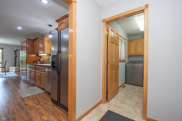 633 Leonards Way, Argusville, ND 58005 - kitchen featuring washer / clothes dryer, appliances with stainless steel finishes, recessed lighting, backsplash, and light wood-style floors