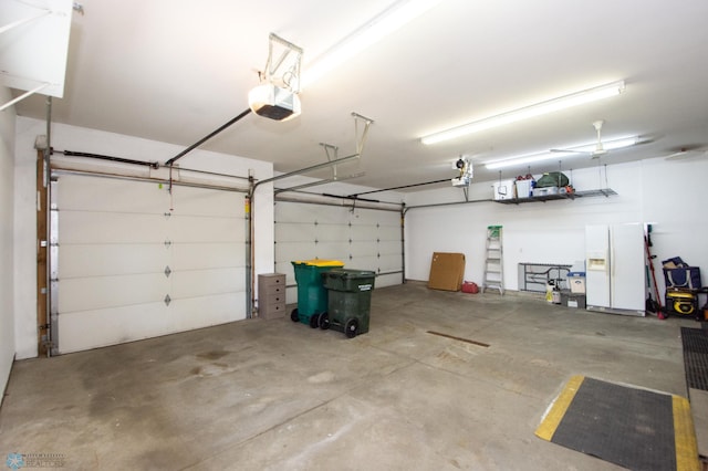 633 Leonards Way, Argusville, ND 58005 - garage featuring white fridge with ice dispenser and a garage door opener