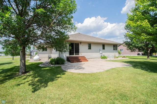 633 Leonards Way, Argusville, ND 58005 - back of house featuring a yard, a patio area, and roof with shingles
