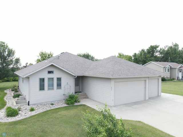 633 Leonards Way, Argusville, ND 58005 - ranch-style home featuring a garage, concrete driveway, a front yard, and roof with shingles