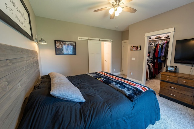 695 Marcus Pl NE, Byron, MN 55920 - bedroom featuring a barn door, light carpet, a closet, ceiling fan, and a spacious closet
