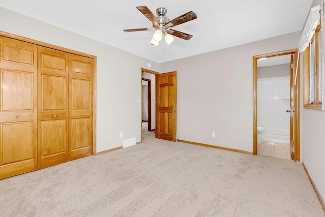 1420 17th St W, Hastings, MN 55033 - unfurnished bedroom with carpet, connected bathroom, a closet, and a ceiling fan