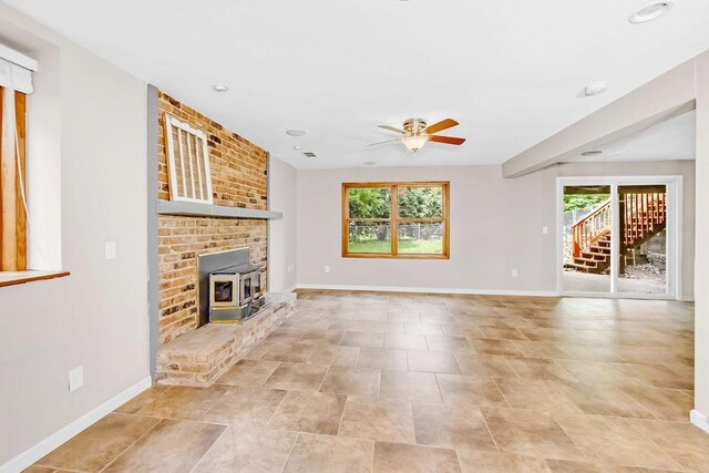 1420 17th St W, Hastings, MN 55033 - unfurnished living room featuring a ceiling fan, a wood stove, and recessed lighting